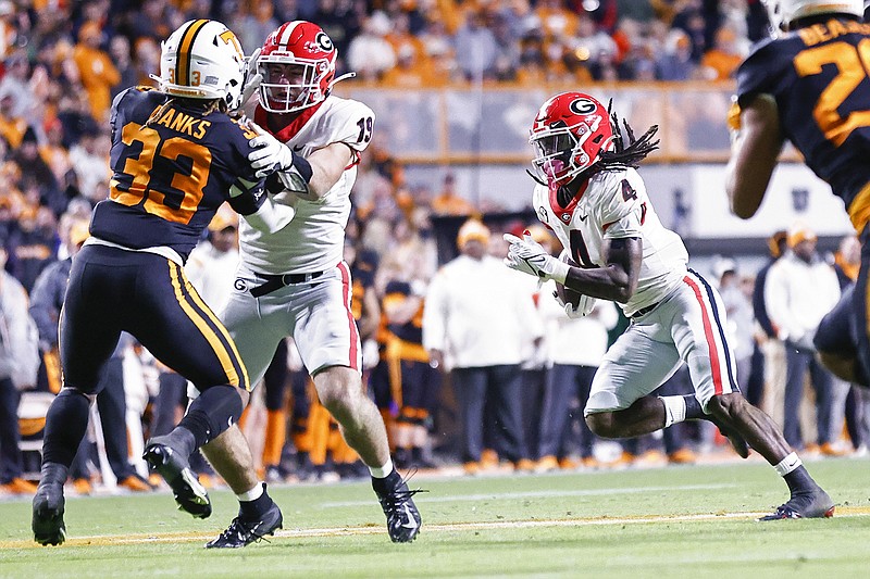 AP photo by Wade Payne / Georgia running back James Cook carries the ball during the second half of the Bulldogs' 41-17 win at Tennessee on Saturday.