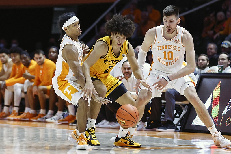 AP photo by Wade Payne / East Tennessee State guard Jordan King, middle, has the ball knocked away by Tennessee guard Zakai Zeigler, left, as forward John Fulkerson also defends during Sunday's game in Knoxville.