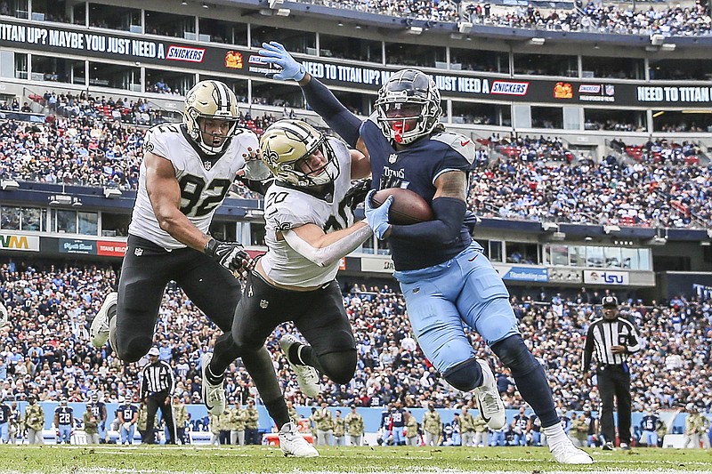 AP photo by Gary McCullough / New Orleans Saints defensive end Marcus Davenport (92) and linebacker Pete Werner pursue Tennessee Titans running back D'Onta Foreman during Sunday's game in Nashville.