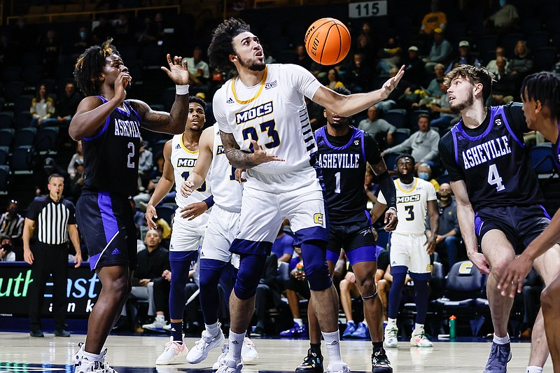 Staff photo by Troy Stolt / UTC's Avery Diggs (23) grabs a rebound during Sunday's game against UNC Asheville at McKenzie Arena.