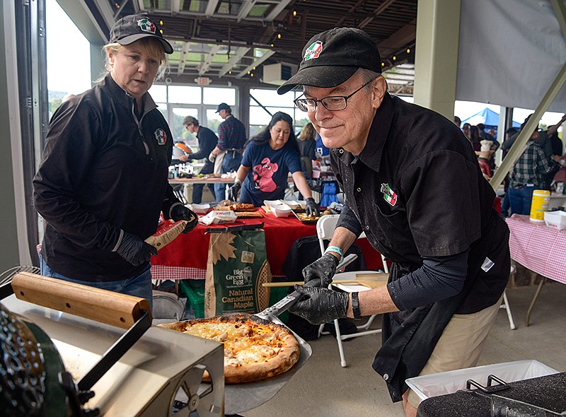 Photo by Mark Gilliland / Cortlandt Minnich bakes a pizza on a Big Green Egg.