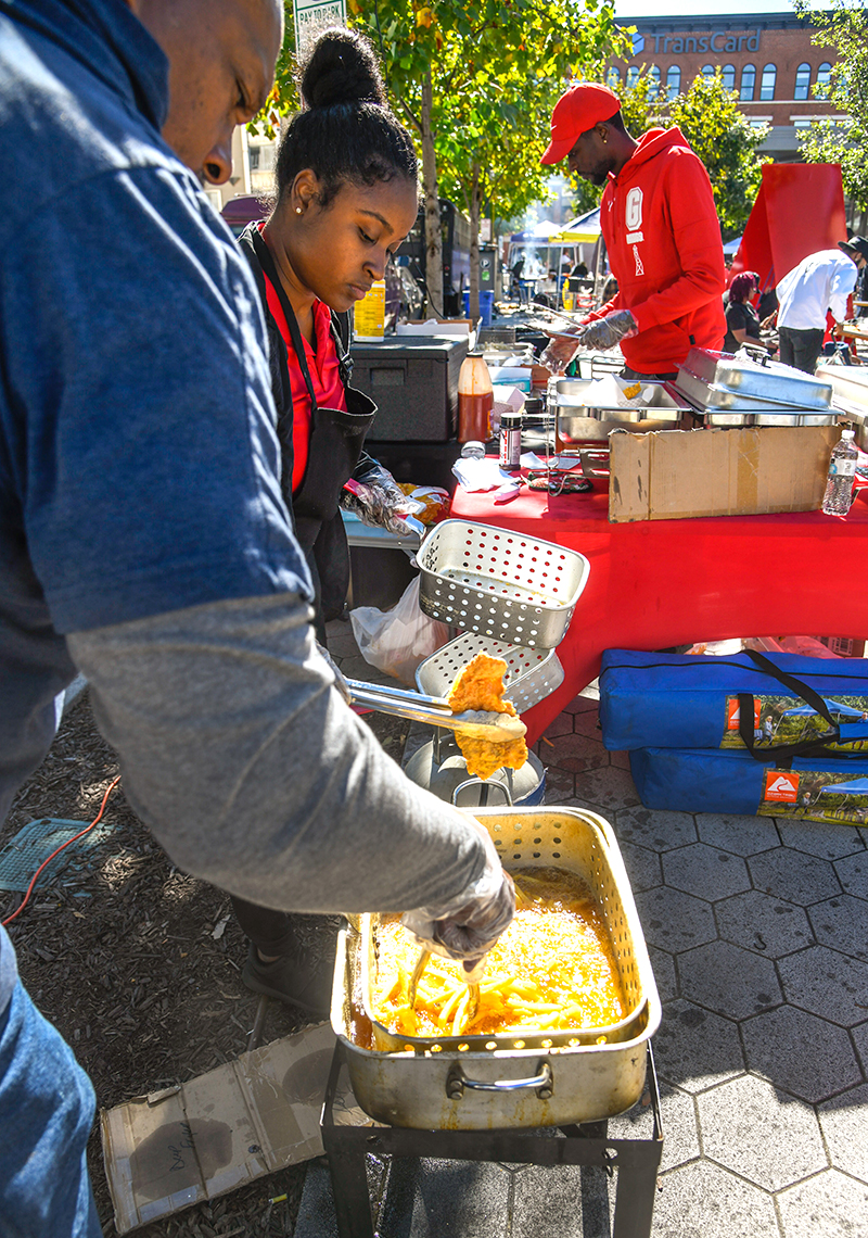 Photo by Mark Gilliland / Jerry and Natiece Nelson and Darrell Johnson fry up some whiting and fries.