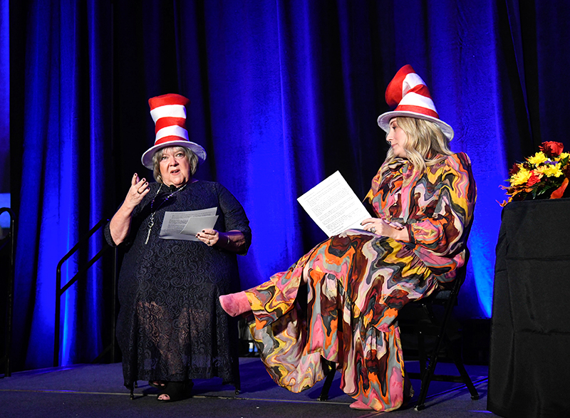 Photo by Mark Gilliland / Donna McConnico and Nicole Watson perform a skit on stage, wearing their Dr. Seuss hats.