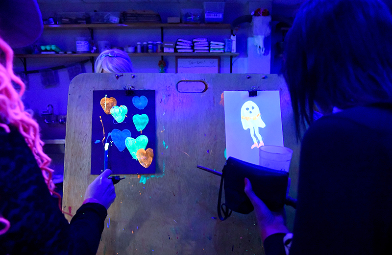 Photo by Mark Gilliland / Attendees make blacklight paintings.