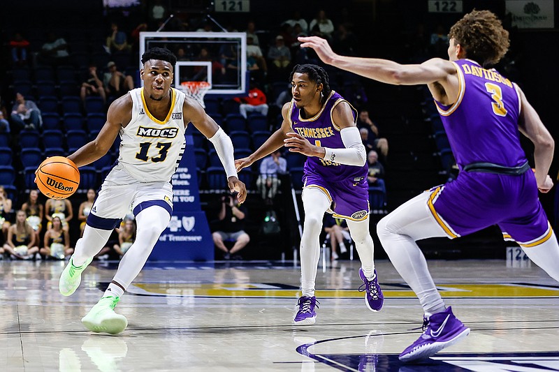 Staff photo by Troy Stolt / UTC guard Malachi Smith (13) drives to the basket during a home game against Tennessee Tech on Tuesday. In Saturday's victory at VCU, Smith scored 20 points and made the winning shot.