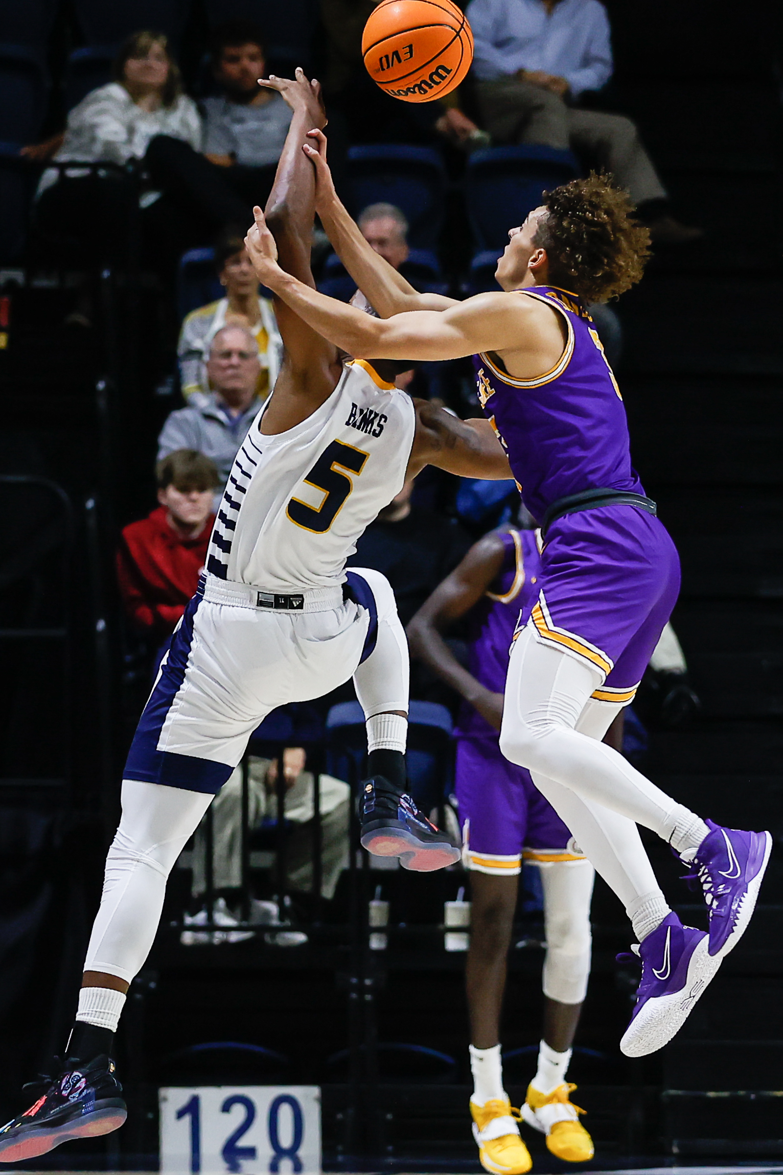 Staff photo by Troy Stolt / Mocs forward Darius Banks (5) is filed by Tennessee Tech Golden Eagles guard Jr. Clay (4) during UTC's home basketball game against the Tennessee Tech Golden Eagles at McKenzie Arena on Tuesday, Nov. 16, 2021 in Chattanooga, Tenn.