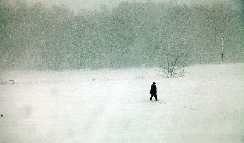 AP file photo by Robert Ray / Scenes like this snowy landscape with a lone figure on Oct. 30, 2012, in Belington, W.Va., might feel coldly familiar to outdoors columnist Larry Case as he ponders how many times he spent his Nov. 15 birthday wet and chilly while out in the field for pleasure or for work.