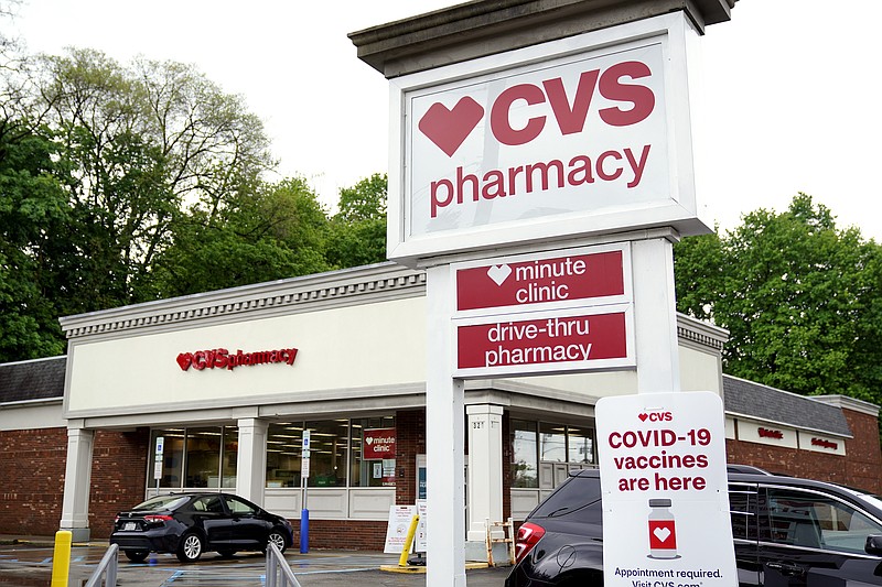 Vehicles are parked in front of a CVS Pharmacy in Mount Lebanon, Pa., on Monday May 3, 2021. CVS Health will close hundreds of drugstores over the next three years, as the retail giant adjusts to changing customer needs and converts to new store formats. The company said Thursday, Nov. 18, that it will close about 300 stores a year for the next three years as it looks to reduce store count density in some locations. (AP Photo/Gene J. Puskar)