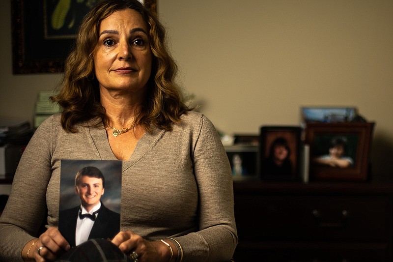 Staff photo by Troy Stolt / Lisa Jarvis poses for a portrait with with photos of her son Logan, who died of a fentanyl overdose on Thursday, Nov. 18, 2021 in Signal Mountain, Tenn.