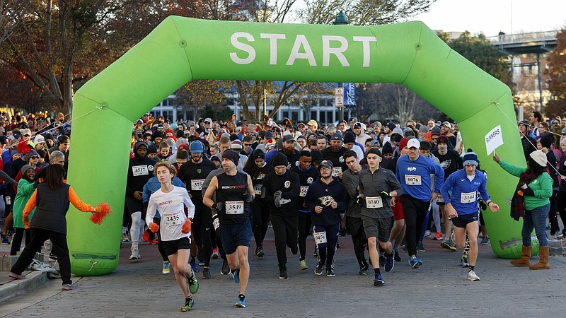 Staff file photo / Runners take off during the 2019 Grateful Gobbler 5K Walk/Run in Chattanooga, one of several events that raise funds for charitable causes on Thanksgiving Day.