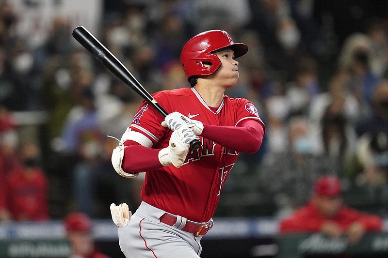 AP photo by Elaine Thompson / The Los Angeles Angels' Shohei Ohtani watches the path of his solo homer against the host Seattle Mariners in the first inning on Oct. 3.