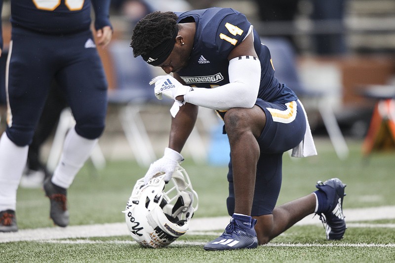 Staff photo by Troy Stolt / UTC cornerback Jordan Jones kneels to pray before the Mocs' game at Western Kentucky on Oct. 24, 2020, in Bowling Green.