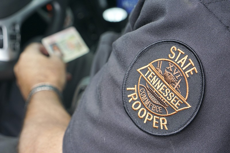 Staff file photo / A Tennessee State Highway Patrol trooper checks an ID and works up a report after inspecting a truck rig during a surprise safety inspection at the Monteagle weigh station on Interstate 24 in 2015.