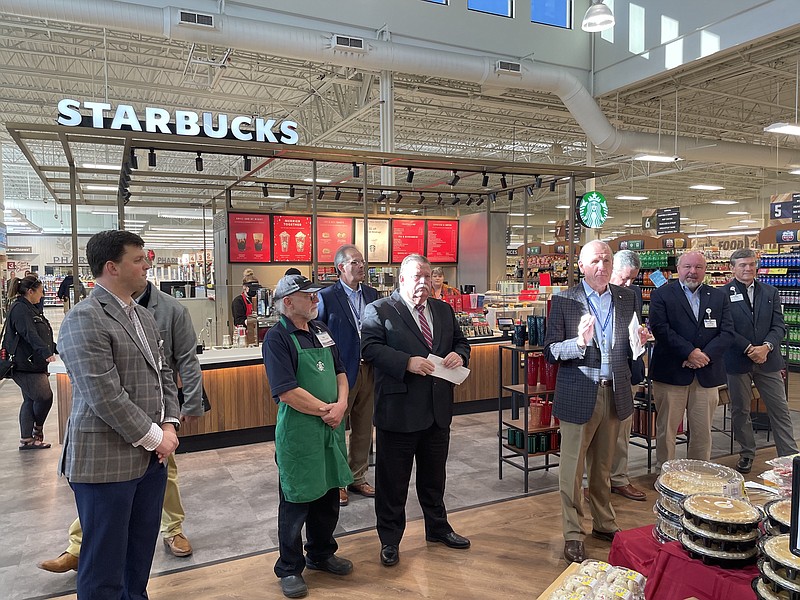 Photo by Dave Flessner / Food City President Seve Smith, center, talks about the new Starbucks outlet at the company's Ooltewah location as Hamilton County Mayor Jim Coppinger, left of Smith, and others listen. The new Starbucks opened Friday and is the 32nd Starbucks outlet operated by Food City.