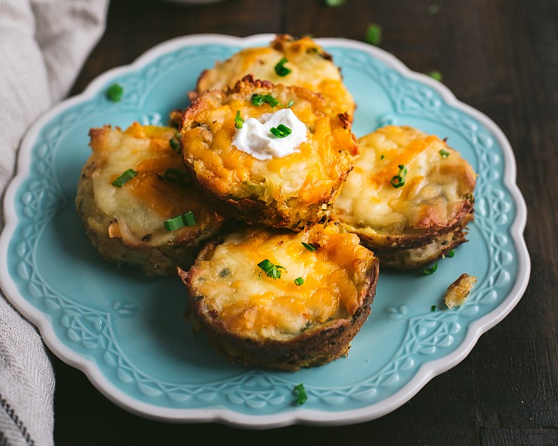 Photo from Idaho Potato Commission / Leftover Mashed Potato Muffins are topped with a dollop of sour cream and a sprinkling of green onions.