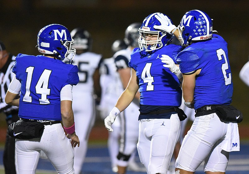 Staff photo by Matt Hamilton / McCallie quarterback William Riddle (14) and receiver Xavier Gaillardetz (2) celebrate with Weston Hammond after he scored a touchdown during Friday's TSSAA Division II-AAA semifinal against Pope John Paull II Prep in Chattanooga.