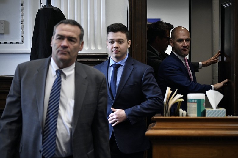 Kyle Rittenhouse, center, enters the courtroom with his attorneys Mark Richards, left, and Corey Chirafisi for a meeting called by Judge Bruce Schroeder at the Kenosha County Courthouse in Kenosha, Wis., on Thursday, Nov. 18, 2021. (Sean Krajacic/The Kenosha News via AP, Pool)


