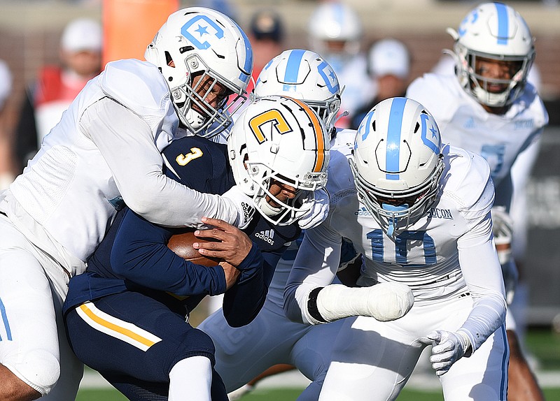 Staff photo by Matt Hamilton / The Citadel's defense converges on UTC quarterback Drayton Arnold after he tucked the ball and ran on third-and-long during Saturday's SoCon game at Finley Stadium.
