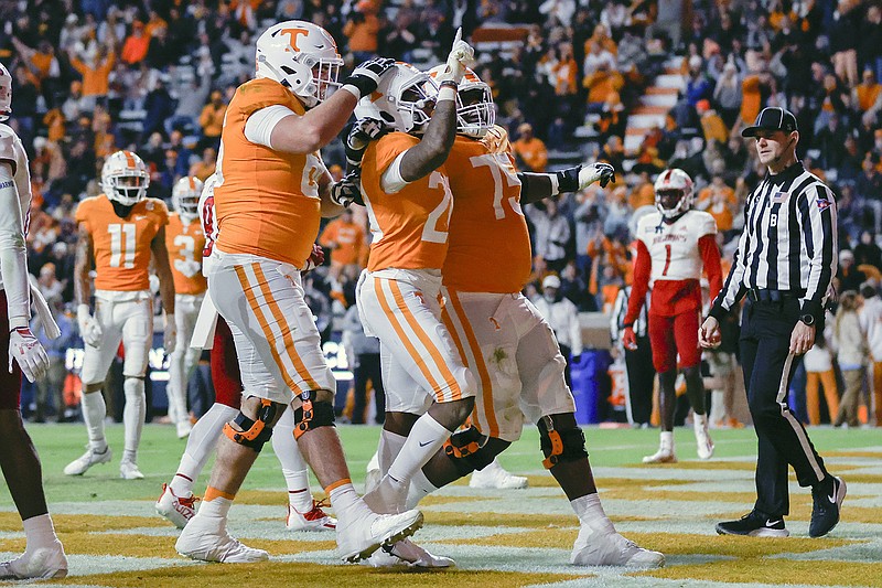 AP photo by Wade Payne / From left, Tennessee's Dayne Davis, Jaylen Wright and Jerome Carvin celebrate after Wright scored on a 17-yard touchdown run in the first quarter of Saturday night's game against South Alabama in Knoxville.