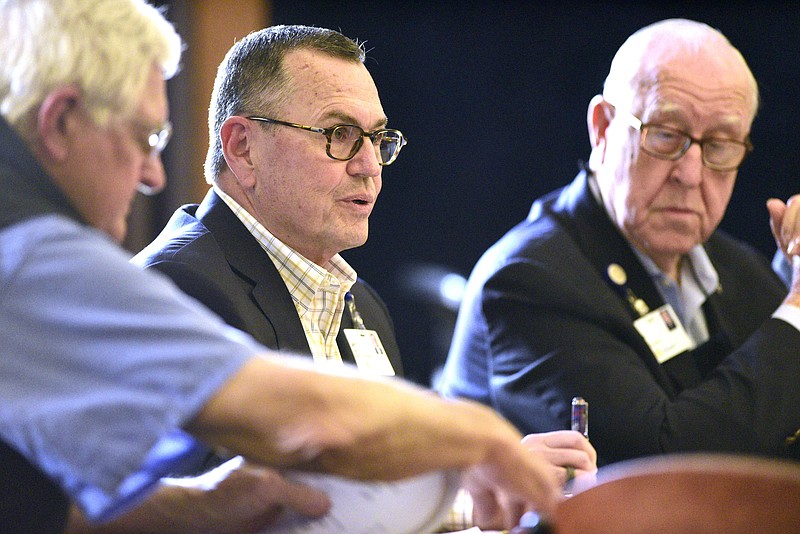 Staff Photo by Robin Rudd / Erlanger trustee Jim Coleman, center, makes a comment at a June 24 meeting of the Erlanger Board of Trustees as Dr. Phil Burns, left, and John Germ listen. The Erlanger board voted Thursday to make Coleman its new chair.