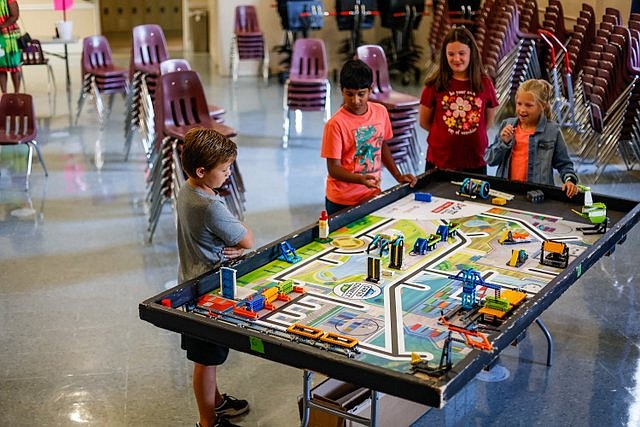 Staff photo by Troy Stolt / From left, Hudson Greene, 9, Jayanth Siddenki, 9, Aubrey McBrayer, 10, and Lauren Commander, 10, plan a strategy for their robots during a workshop at the Chattanooga School for Liberal Arts in August in East Brainerd.