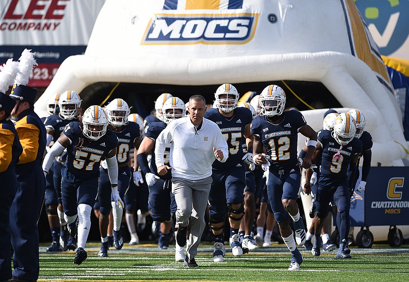 Staff photo by Matt Hamilton / UTC football coach Rusty Wright leads the Mocs onto the field for Saturday's SoCon game against The Citadel at Finley Stadium.