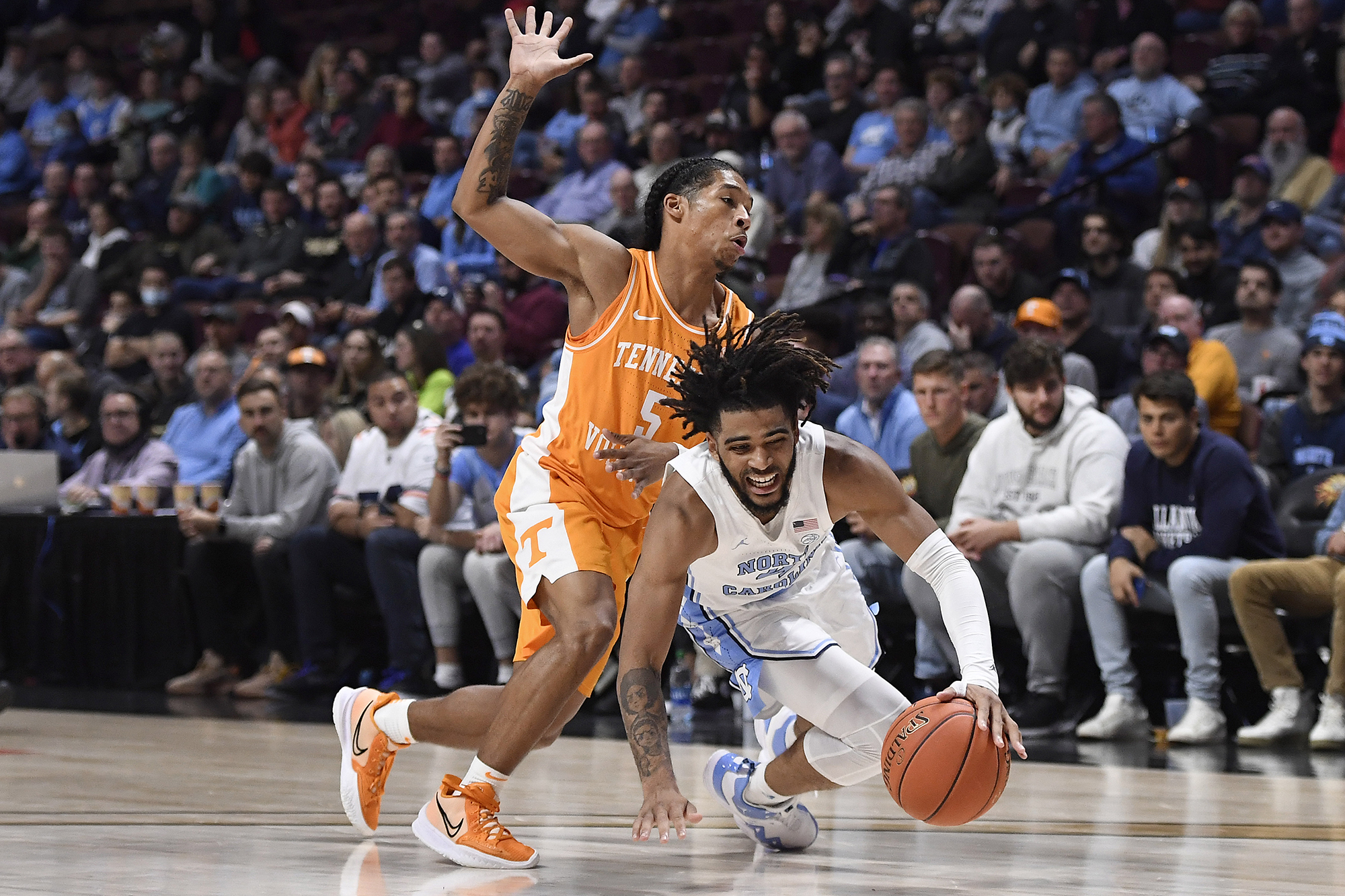 AP photo by Jessica Hill / Tennessee's Zakai Zeigler, left, fouls North Carolina's R.J. Davis in the second half of the consolation game of the Hall of Fame Tip-Off Tournament on Sunday in Uncasville, Conn.