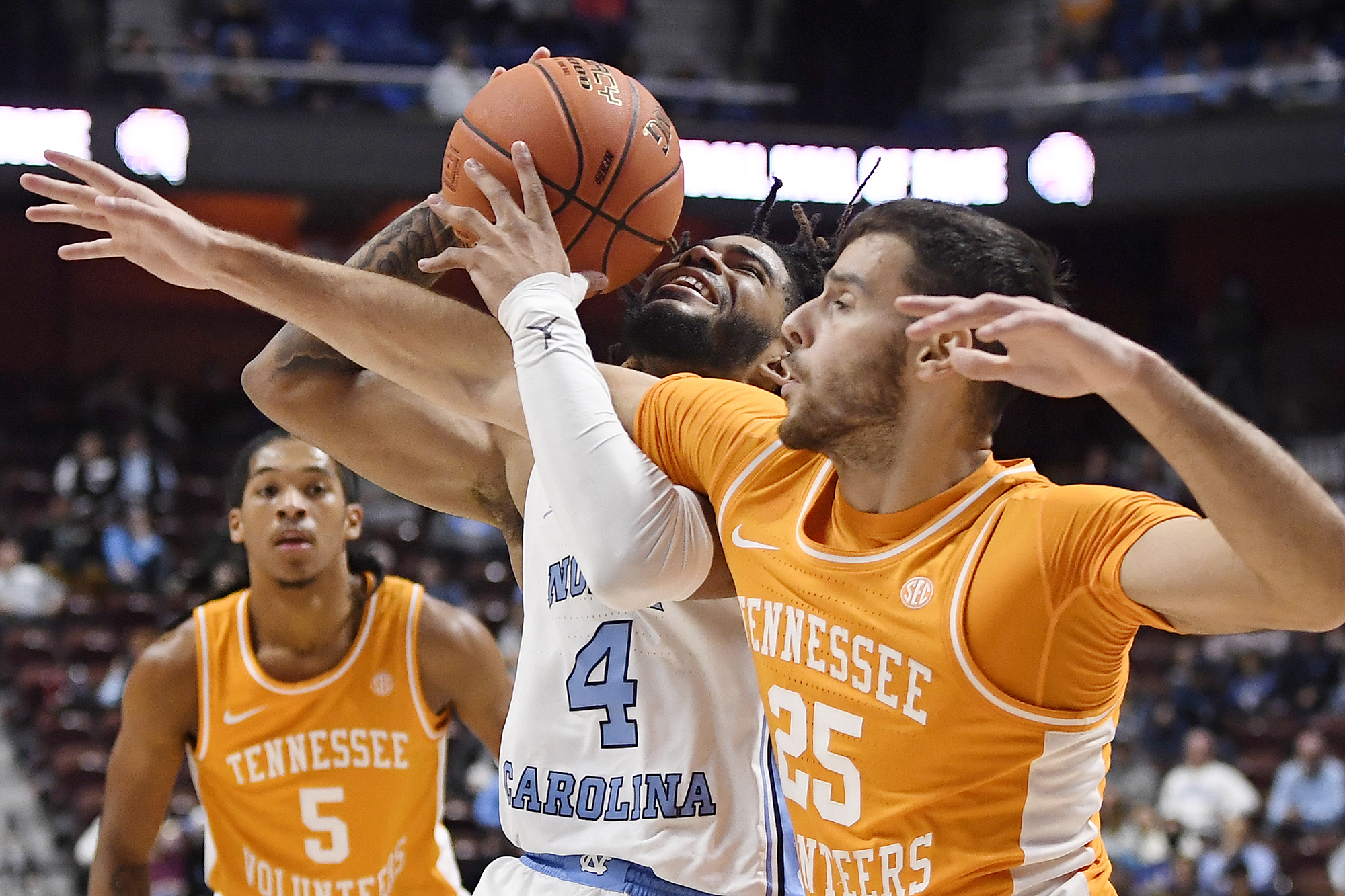 AP photo by Jessica Hill / North Carolina's R.J. Davis (4) is fouled by Tennessee's Santiago Vescovi (25) in the second half of the consolation game of the Hall of Fame Tip-Off Tournament on Sunday in Uncasville, Conn.
