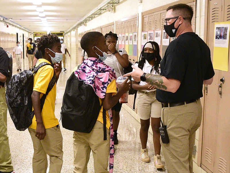 Staff file Photo by Robin Rudd / Orchard Knob Middle School Sixth Grade Assistant Principal Travis Miller, right, directs students. Orchard Knob Middle School started the 2021-2022 school year under a Hamilton County Schools system-wide mask mandate on August 12 because of the surge in the delta variant of COVID-19.