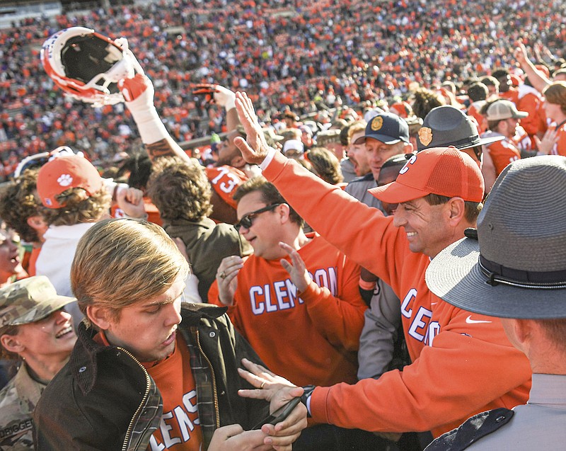 Clemson head coach Dabo Swinney is greeted at midfield after an NCAA college football game against Wake Forest, Saturday, Nov. 20, 2021, at Memorial Stadium in Clemson, S.C. (Ken Ruinard/The Independent-Mail via AP)