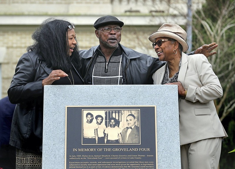 FILE - Relatives of the Groveland Four, from left, Vivian Shepherd, niece of Sam Shepherd, Gerald Threat, nephew of Walter Irvin; Carol Greenlee, daughter of Charles Greenlee, gather at the just-unveiled monument in front of the Old Lake County courthouse in Tavares, Fla., Feb. 21, 2020. Florida has formally cleared four Black men who were falsely accused of raping a white woman more than seven decades ago. At the request of the local prosecutor, a judge on Monday, Nov. 22, 2021 dismissed the charges and convictions against the Groveland Four: Ernest Thomas, Samuel Shepherd, Charles Greenlee and Walter Irvin. (Joe Burbank/Orlando Sentinel via AP)

