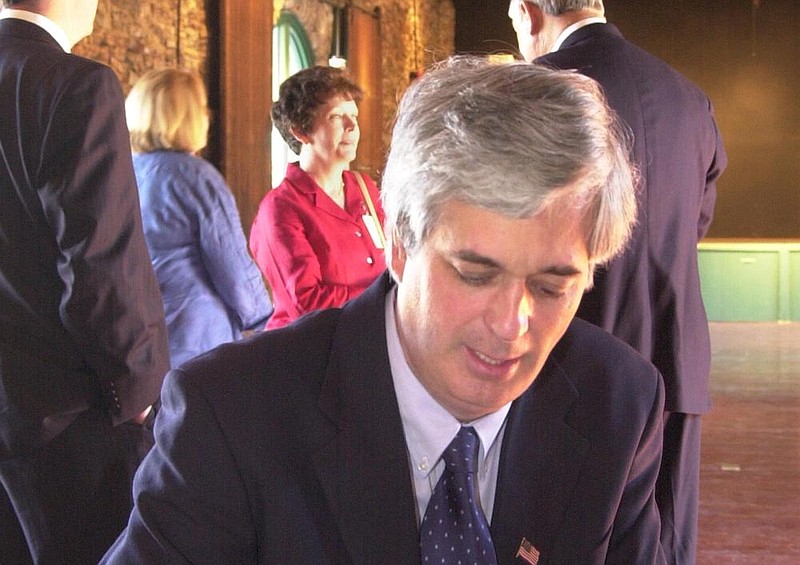 Staff file photo / Chris Dortch signs a copy of his book, "Northwest Georgia Bank" at the Ringgold Depot.