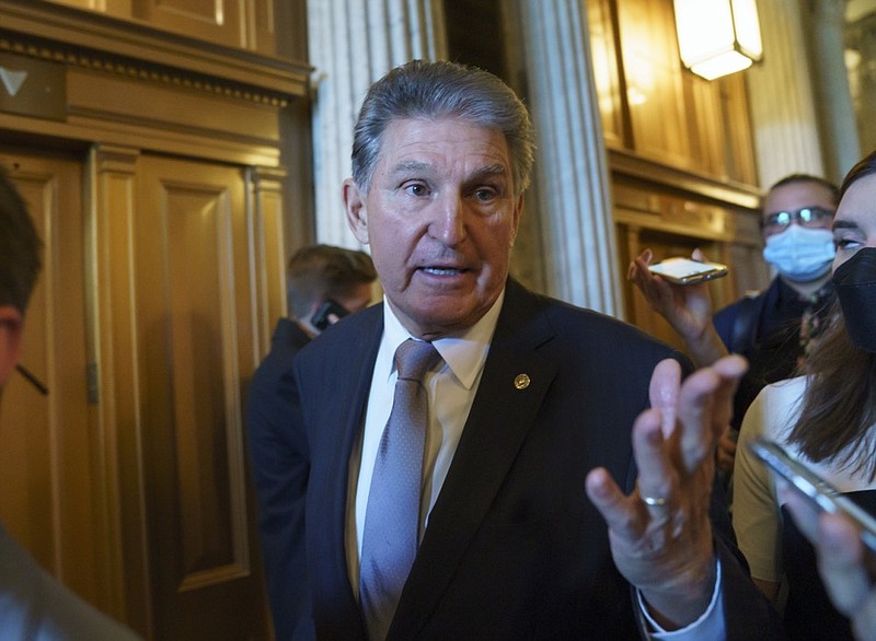 FILE - Sen. Joe Manchin, D-WVa., talks to reporters as he leaves the chamber after a vote, at the Capitol in Washington, on Nov. 3, 2021. (AP Photo/J. Scott Applewhite, File)


