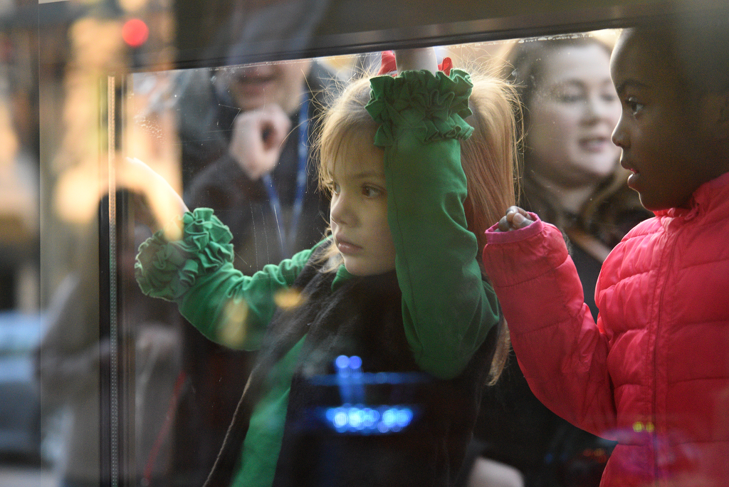 Staff Photo by Matt Hamilton / Isabelle Shrader, 4, and Jayde Ballard, 5, right, look at the scenes after they were revealed at EPB headquarters on Wednesday, November 24, 2021.