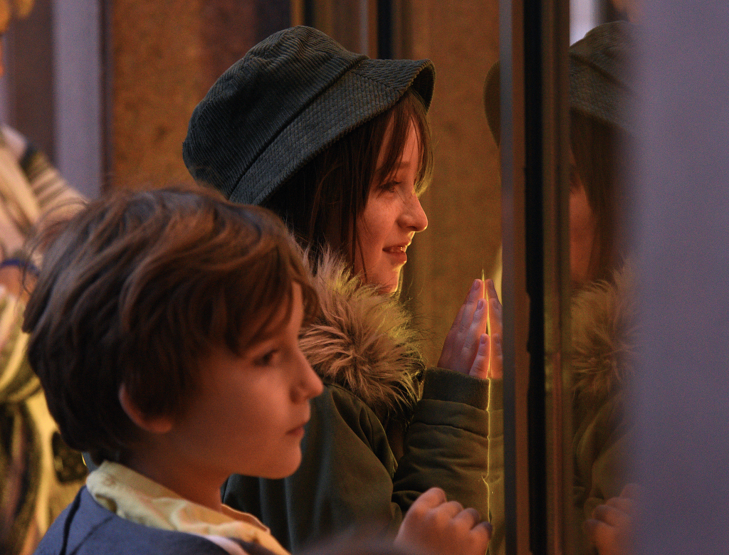 Staff Photo by Matt Hamilton / Sophie Wagner, back, and Jackson Feagans, both 9, look at the scenes through the windows at EPB headquarters on Wednesday, November 24, 2021.