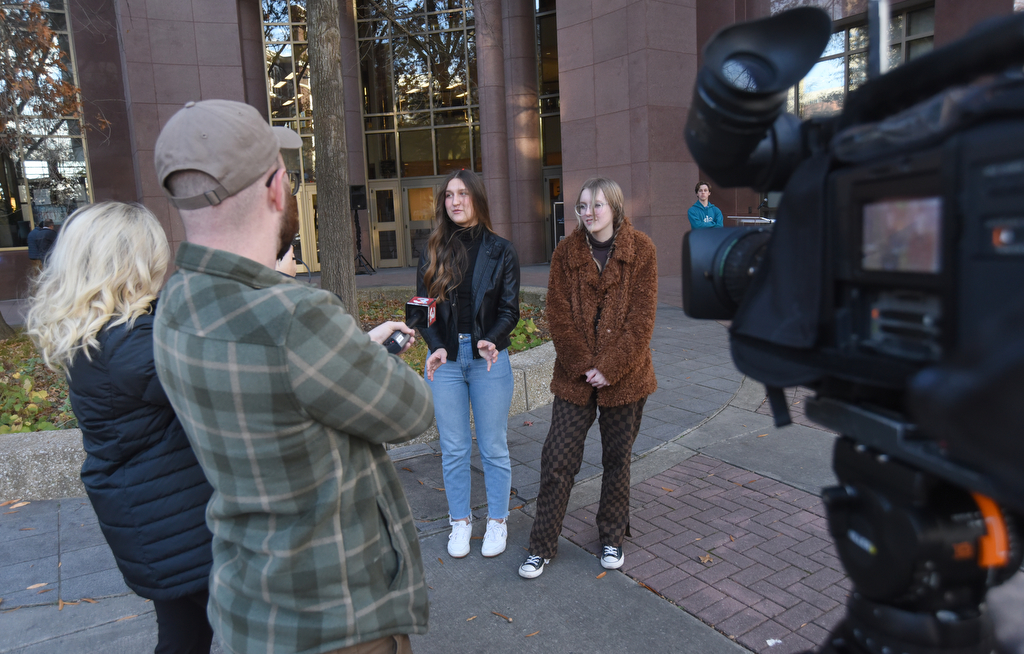 Staff Photo by Matt Hamilton / STEM School Chattanooga students Juliana Burlaka, left, and Zoe Howard, both 16, answer questions about designing aspects of the windows before they were revealed at EPB headquarters on Wednesday, November 24, 2021.