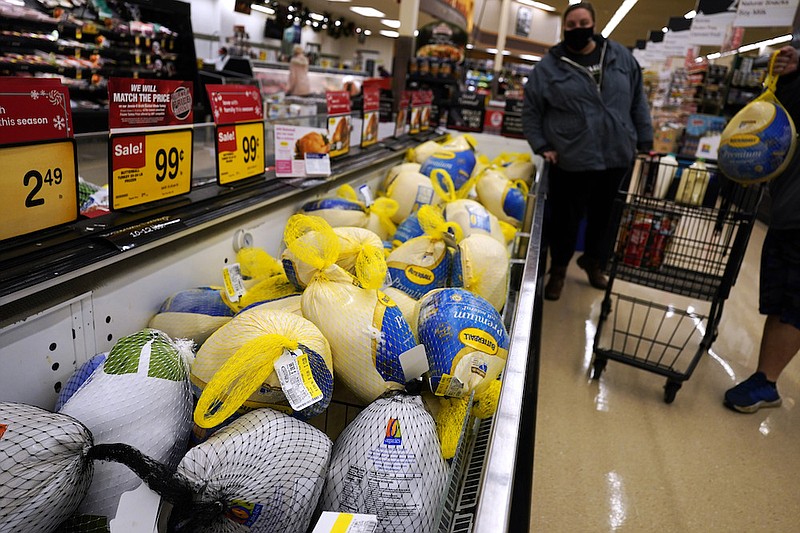 People shop for frozen turkeys for Thanksgiving dinner at a grocery store in Mount Prospect, Ill., Wednesday, Nov. 17, 2021. First, the good news: There is no shortage of whole turkeys in the U.S. this Thanksgiving. But those turkeys - along with other holiday staples like cranberry sauce and pie filling - could cost more. (AP Photo/Nam Y. Huh)