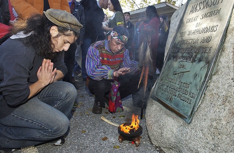 Supporters of Native Americans pause following a prayer during the 38th National Day of Mourning at Coles Hill in Plymouth, Mass., on Nov. 22, 2007. Denouncing centuries of racism and mistreatment of Indigenous people, members of Native American tribes from around New England will gather on Thanksgiving 2021 for a solemn National Day of Mourning observance. (AP Photo/Lisa Poole, File)
