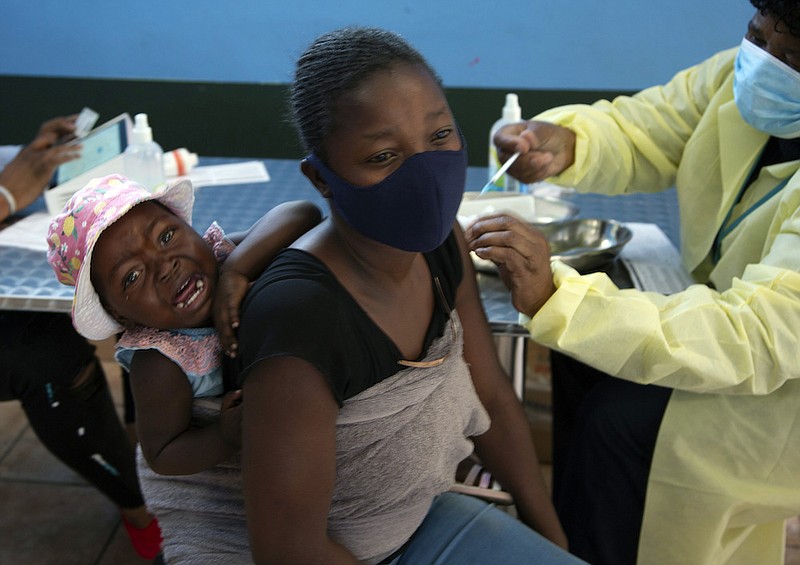 A baby cries as her mother receives her Pfizer vaccine against COVID-19, in Diepsloot Township near Johannesburg Thursday, Oct. 21, 2021. A new COVID-19 variant has been detected in South Africa that scientists say is a concern because of its high number of mutations and rapid spread among young people in Gauteng, the country's most populous province, Minister of Health Joe Phaahla announced Thursday, Nov. 25, 2021. (AP Photo/Denis Farrell, File)