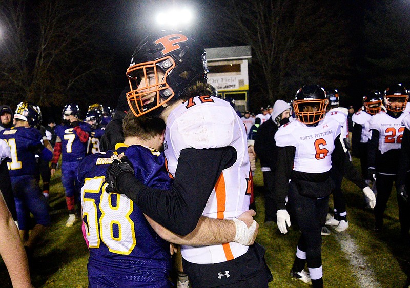 Staff photo by Robin Rudd /  South Pittsburg's Reid Peacock (72) consoles Cloudland's Cayden Cordell (58) after the Pirates' 30-22 victory in a TSSAA Class 1A semifinal Friday night in Roan Mountain, Tenn.