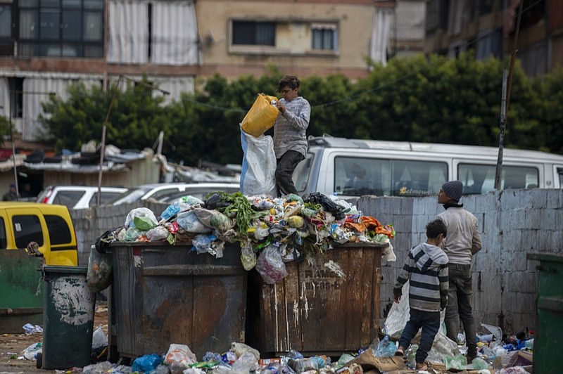 FILE - Children search for valuables in the garbage next to a market in Beirut, Lebanon, Monday, April 12, 2021. Lebanon's severe economic crisis that threw much of the population into poverty is dramatically affecting children leaving some go to bed hungry, lack good medial care and drop out of school to help their families, UNICEF, the U.N. children's agency said Tuesday, Nov. 23, 2021. (AP Photo/Hassan Ammar, File)


