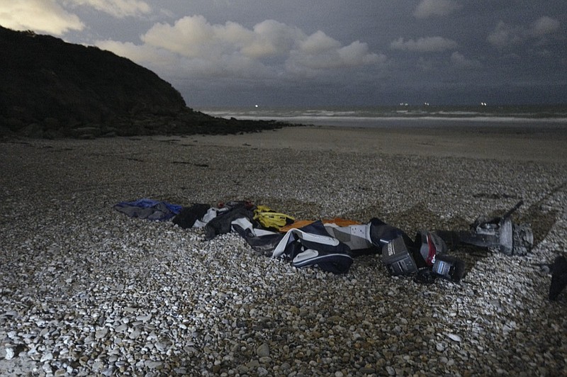 Life jackets, sleeping bags and damaged inflatable small boat are pictured on the shore in Wimereux, northern France, Friday, Nov. 26, 2021 in Calais, northern France. Children and pregnant women were among at least 27 migrants who died when their small boat sank in an attempted crossing of the English Channel, a French government official said. (AP Photo/Rafael Yaghobzadeh)


