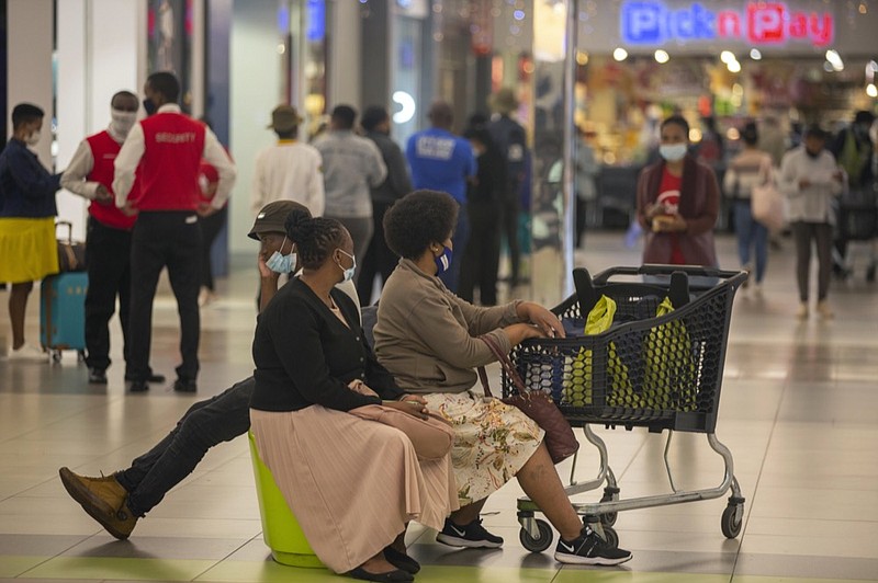 People shop in a mall, in Johannesburg, South Africa, Friday Nov. 26, 2021. (AP Photo/Denis Farrell)


