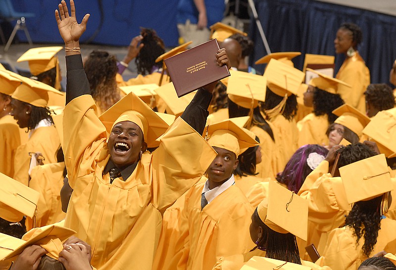 Staff file photo / Students celebrate after receiving their diplomas in May 2010 from Howard High School at the McKenzie Arena in Chattanooga, Tennessee.
