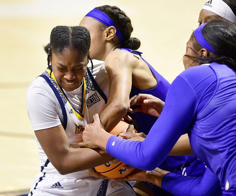 Staff photo by Robin Rudd / UTC's Destiny McClendon, left, fights for the basketball during Saturday's nonconference game against Georgia State at McKenzie Arena.