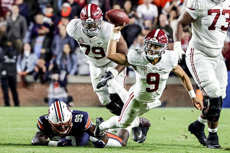 AP photo by Butch Dill / Alabama quarterback Bryce Young (9) is tackled by Auburn defensive end T.D. Moultry (99) while trying to pass during Saturday's Iron Bowl rivalry game in Auburn, Ala.