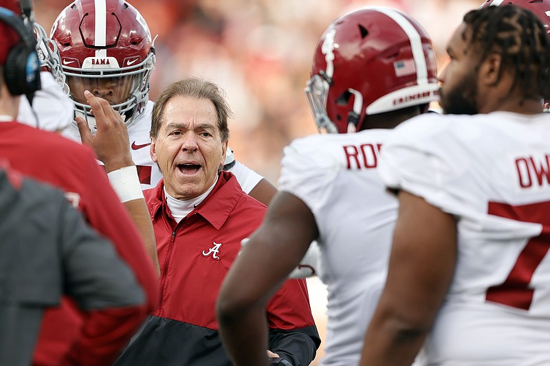 AP photo by Butch Dill / Alabama football coach Nick Saban talks with his players during a timeout in the first half of Saturday's game at Auburn.