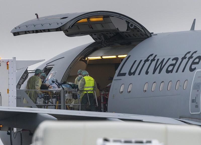A patient with the COVID-19 disease is load into a German air forces Luftwaffe aircraft at the airport in Memmingen, Germany, Friday, Nov. 26, 2021. (Peter Kneffel/dpa via AP)


