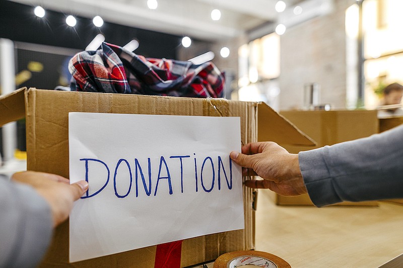 Donation box full of clothes and toys. / Getty Images/iStock/mixetto