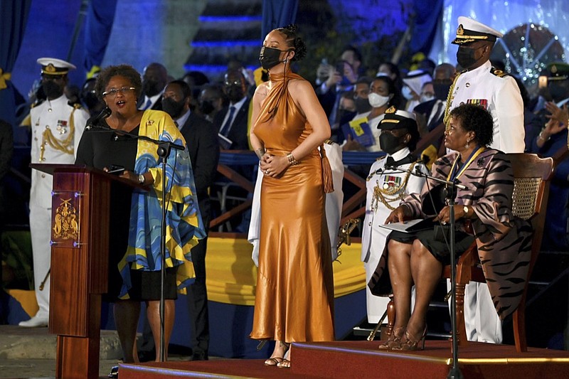 Barbados' Prime Minister Mia Mottley, left, and President of Barbados, Dame Sandra Mason, right, honour Rihanna as a National Hero, during the Presidential Inauguration Ceremony, at Heroes Square, in Bridgetown, Barbados, Tuesday, Nov. 30, 2021. (Jeff J Mitchell PA via AP)


